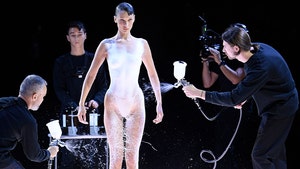 Bella Hadid Walks Runway Topless, Gets Dress Spray-Painted On At Fashion Show