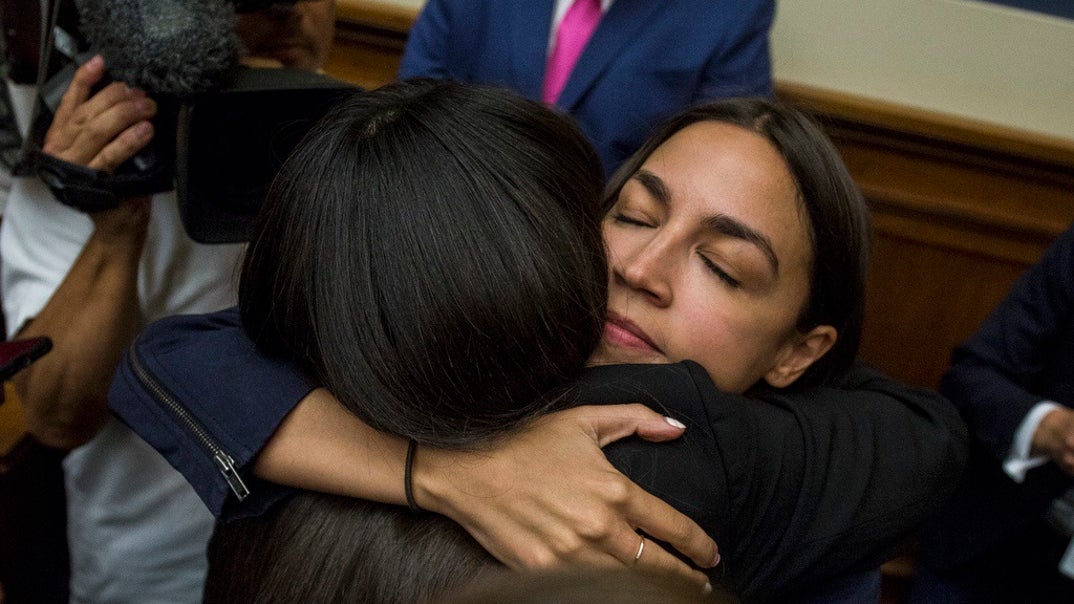 Rep. Alexandria Ocasio-Cortez (D-NY) hugs Yazmin Juarez, whose 19-month-old daughter Mariee died after detention by ICE, following a House Oversight and Reform subcommittee on Civil Rights and Civil Liberties hearing discussing migrant detention centers' treatment of children on Capitol Hill.