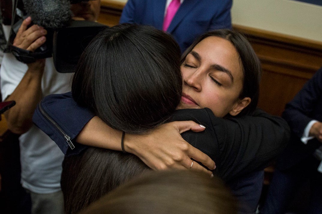 Rep. Alexandria Ocasio-Cortez (D-NY) hugs Yazmin Juarez, whose 19-month-old daughter Mariee died after detention by ICE, following a House Oversight and Reform subcommittee on Civil Rights and Civil Liberties hearing discussing migrant detention centers' treatment of children on Capitol Hill.