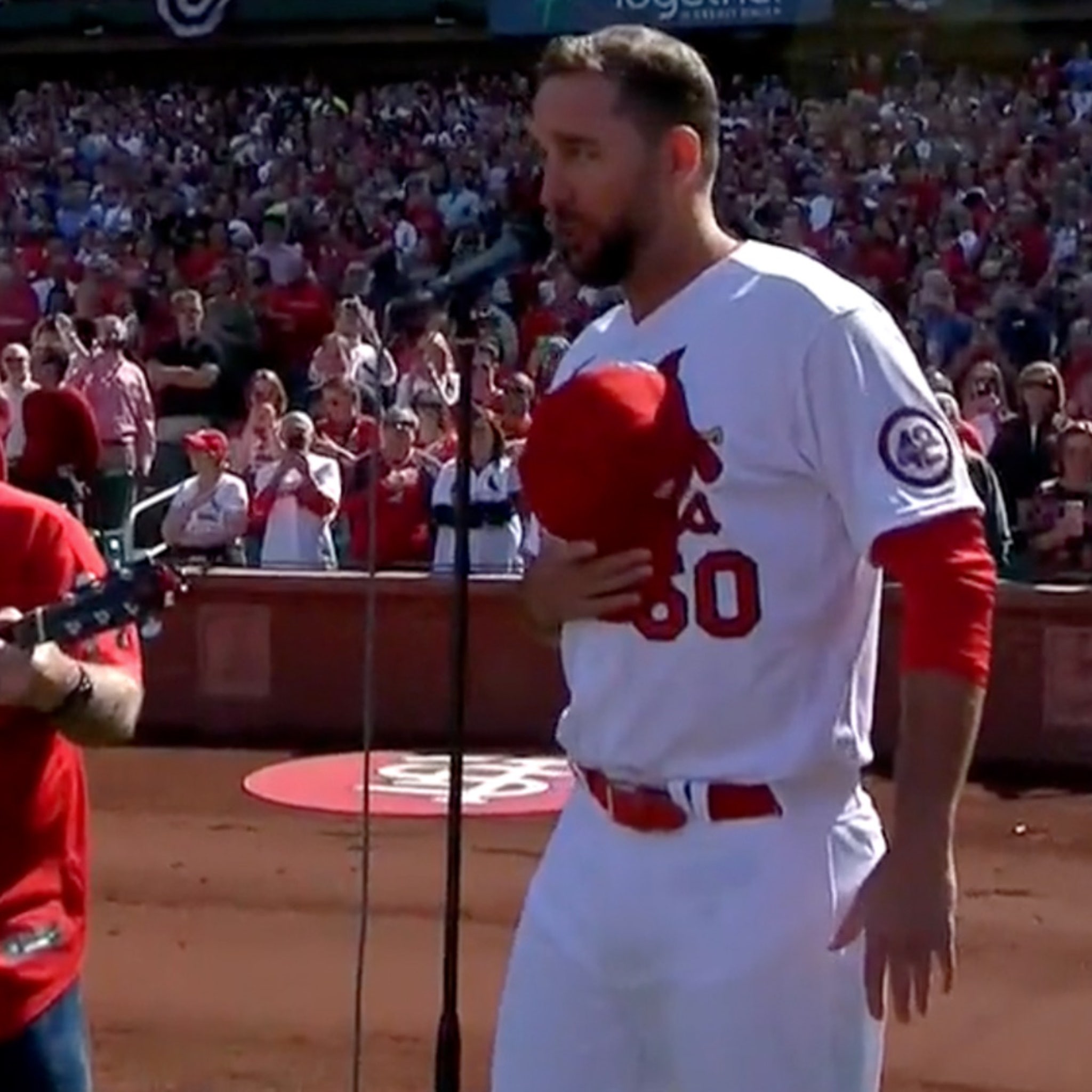 The St. Louis Cardinals line up during the national anthem wearing