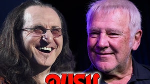 Geddy Lee and Alex Lifeson are smiling behind Rush's logo. Lee's wearing a brown jacket and a black t-shirt, while Lifeson's wearing a black button-up shirt.