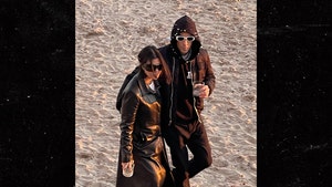 Kourtney Kardashian and Travis Barker Bundle Up for Walk on the Beach