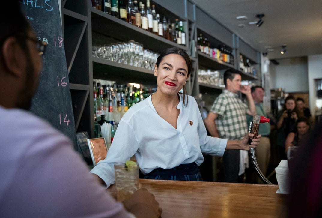 Rep. Alexandria Ocasio-Cortez (D-NY) works behind the bar at the Queensboro Restaurant, May 31, 2019 in the Queens borough of New York City. Ocasio-Cortez participated in an event to raise awareness for the One Fair Wage campaign, which calls to raise the minimum wage for tipped workers to a full minimum wage at the federal level.
