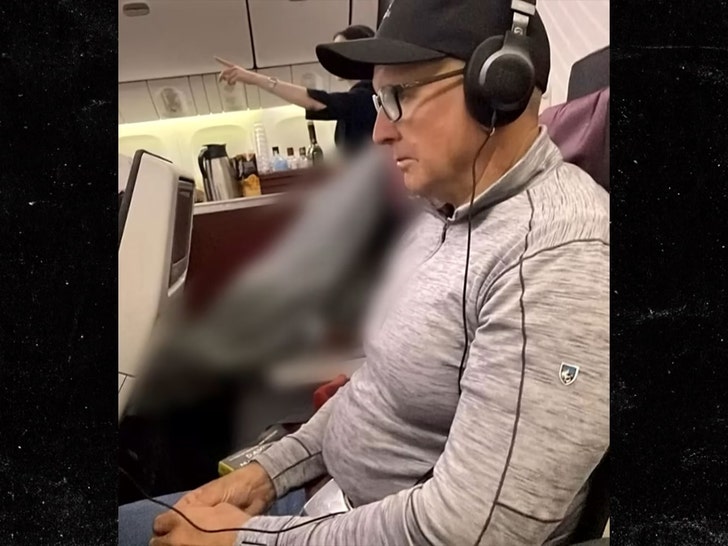 man sits by dead body on plane 1