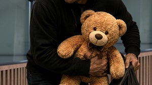 man taking teddy bear