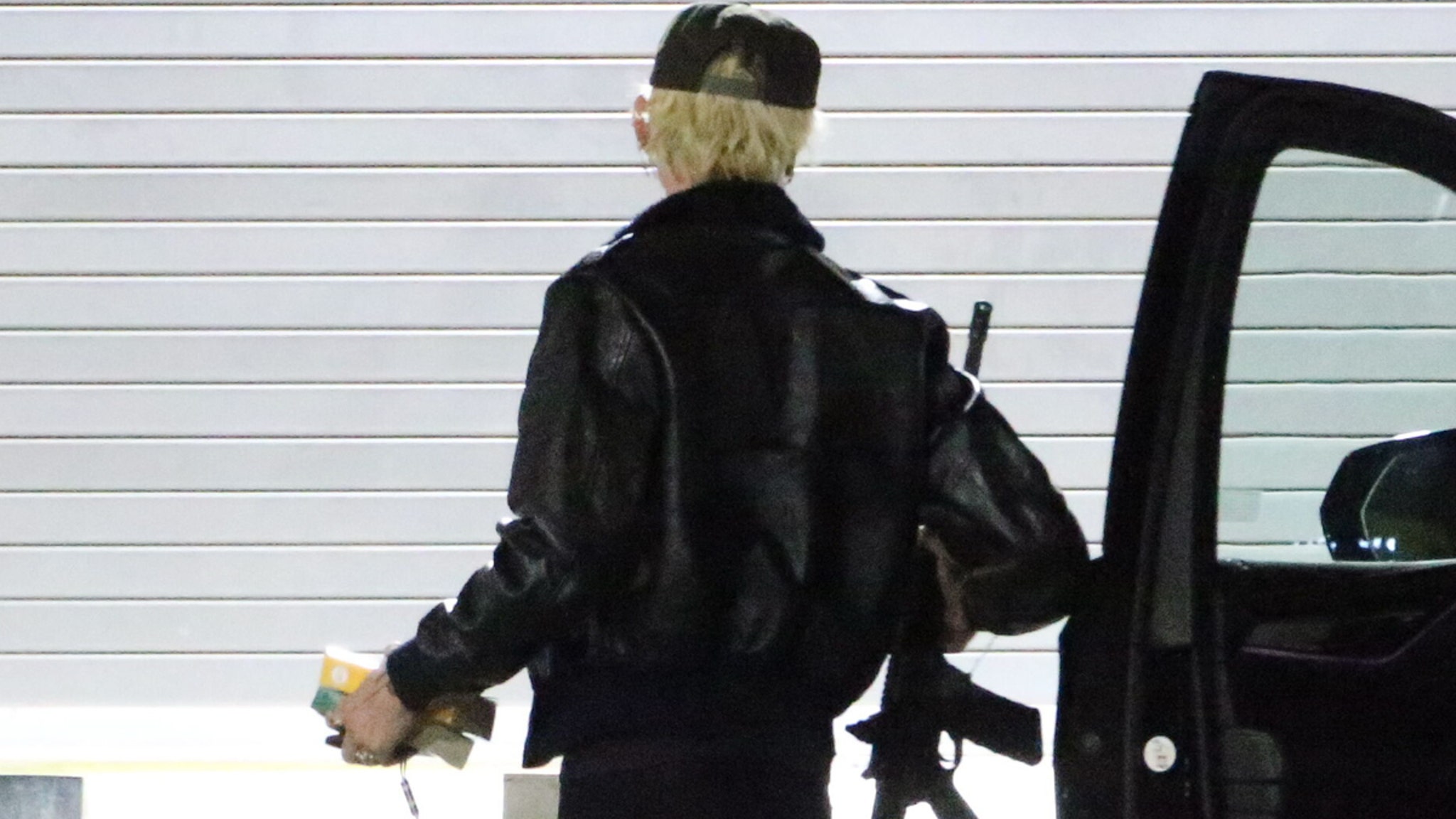 Machine Gun Kelly Walks Into Studio Holding Apparent Assault Rifle
