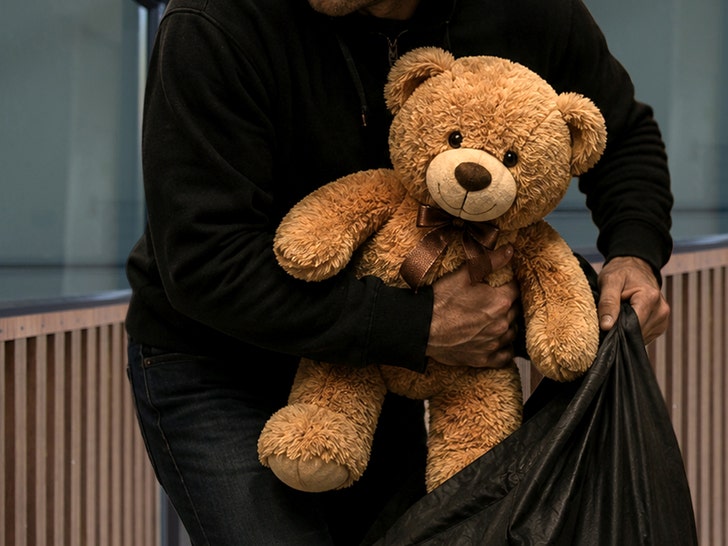 man taking teddy bear