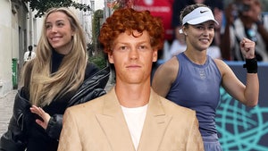 A man wearing a white t-shirt and beige double-breasted jacket is flanked by two women. The woman on his right is walking down a street while wearing an oversized black jacket, while the woman on his left is bending her arm at a tennis match, and she's wearing a dark blue top and matching shorts, as well as a white Nike visor.