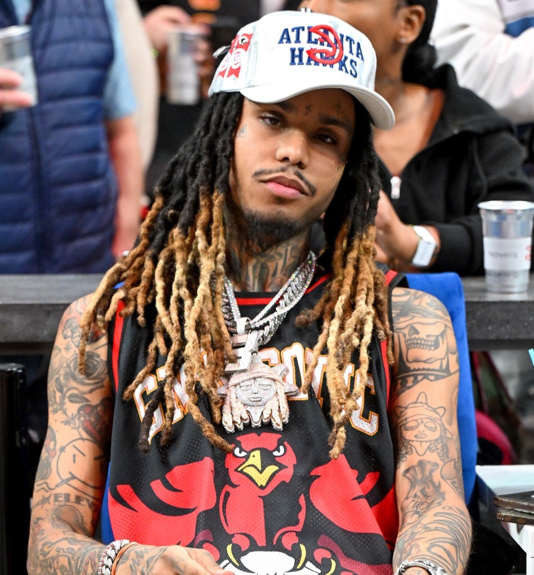 Lil Gnar keeps a stoic demeanor while attendsing the 76ers and Hawks game at State Farm Arena on March 10, 2025 in Atlanta