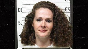 Christa Pike is seen posing for a mugshot. She's wearing a white shirt.