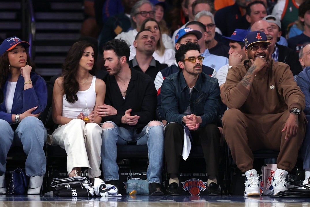 Jonas Bros sit courtside with Carmelo Anthony during Game Five of the Eastern Conference First Round NBA Playoffs between the Detroit Pistons and the New York Knicks at Madison Square Garden on April 29, 2025 in New York City.