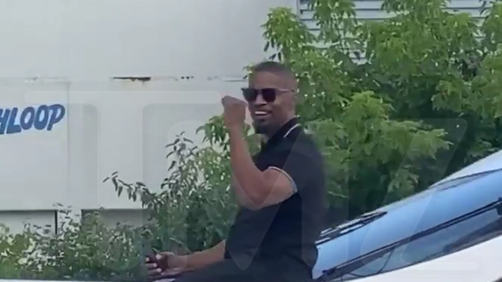 Jamie Foxx waves to fans on a boat, the first sighting since his hospitalization