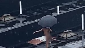 NYC Dweller Does Naked Rooftop Dancing in the Rain, Umbrella Included