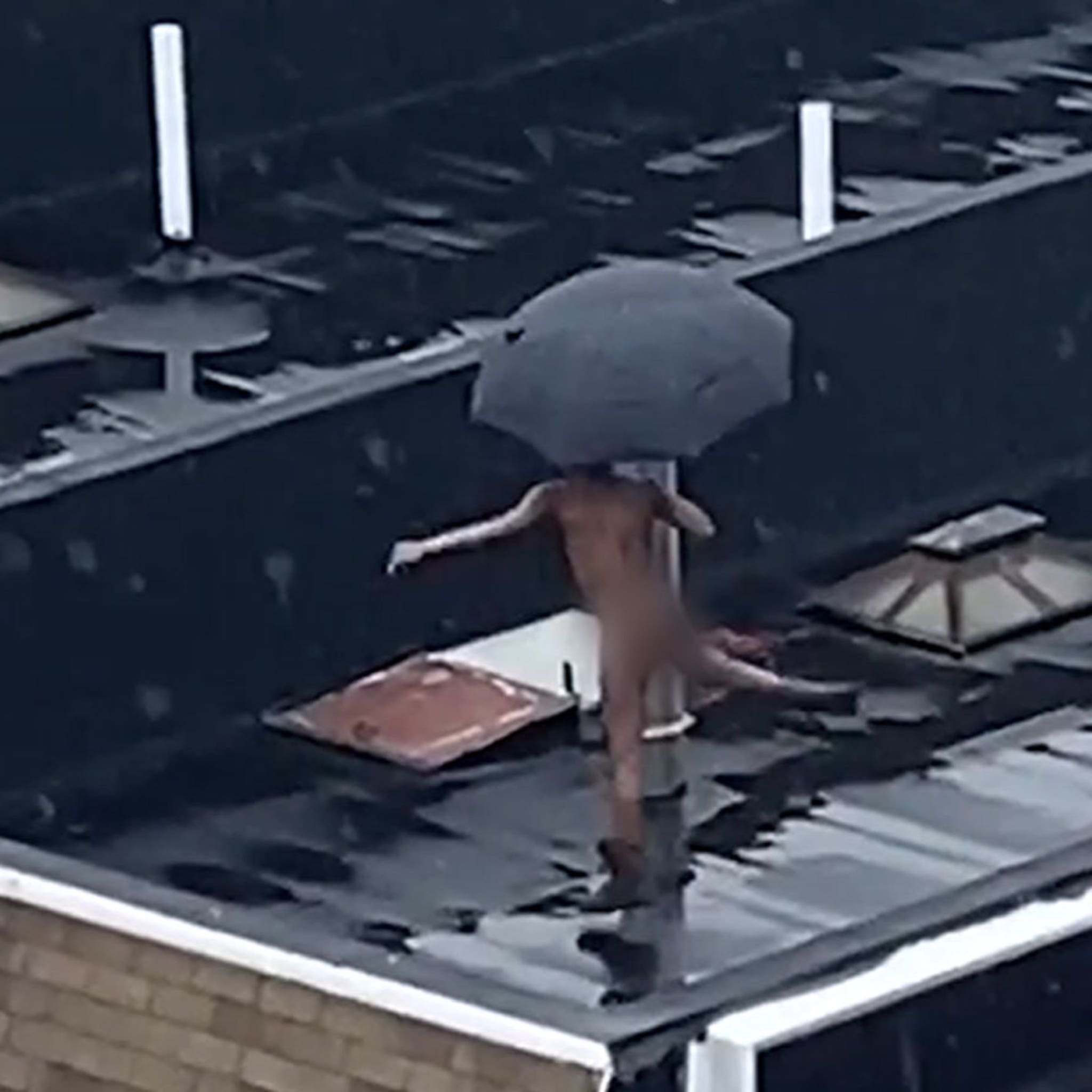 NYC Dweller Does Naked Rooftop Dancing in the Rain, Umbrella Included