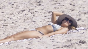 Jessica Alba Tanning On A Beach Wearing A Bikini