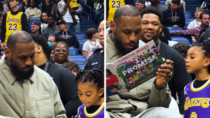 LeBron James Signs Young Fan's 'I Promise' Book During Lakers Game