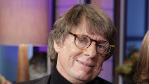 Richard Cohen Smiling While Wearing Glasses And A Black Turtleneck Shirt