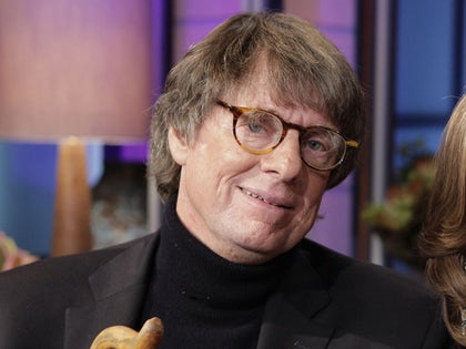 Richard Cohen Smiling While Wearing Glasses And A Black Turtleneck Shirt