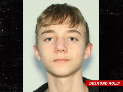 Desmond Holly is seen while posing for a photo. He's wearing a black sweater in the shot.