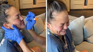 Chrissy Teigen Laughs While Getting Coronavirus Test