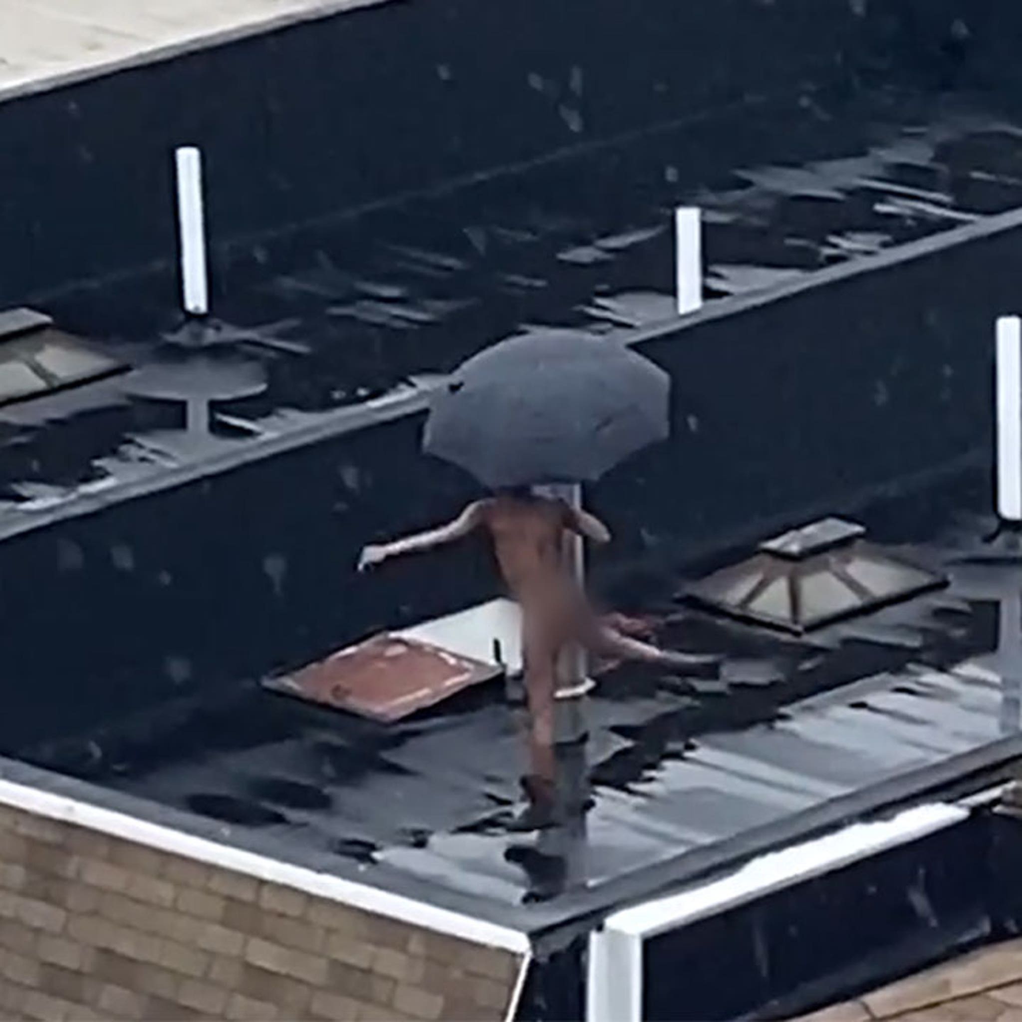 NYC Dweller Does Naked Rooftop Dancing in the Rain, Umbrella Included