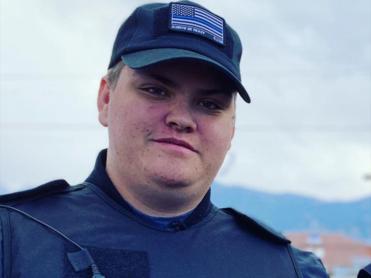 Garry Chapman is smiling while posing for a photo. He's wearing a black vest and a matching shirt with a Blue Lives Matter patch on its front.