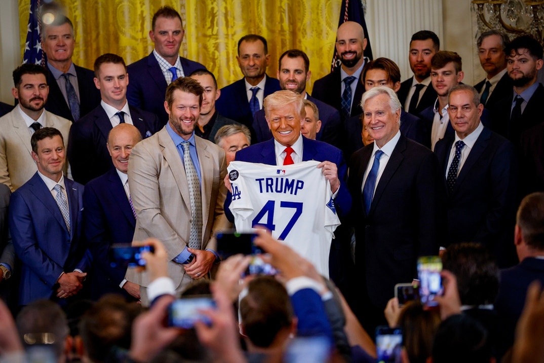 Los Angeles Dodgers pitcher Clayton Kershaw, U.S. President Donald Trump, and Los Angeles Dodgers Owner and Chairman Mark Walter pose with a jersey presented to Trump as he hosts the 2024 World Series champions in the East Room of the White House on April 07, 2025 in Washington, DC. The Los Angeles Dodgers defeated the New York Yankees with a 7-6 victory in Game 5.