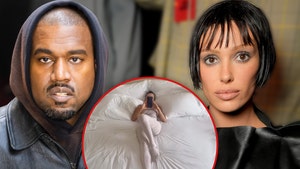 Kanye West Films Bianca Censori Laid Out in Giant Bed with Sexy Outfit