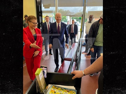 Joe Biden and Karen Bass walking into Los Angeles cafe.