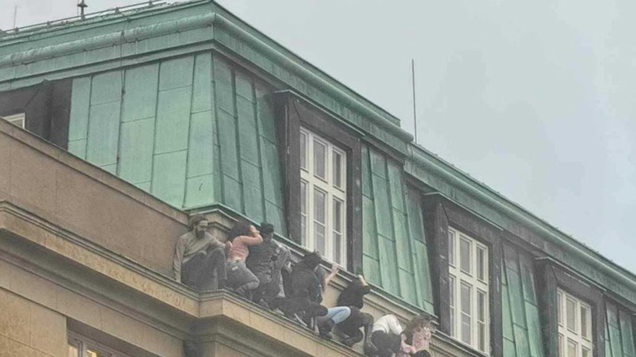 Students Hang Off Edge Of Building To Hide From Gunman in Prague Mass Shooting