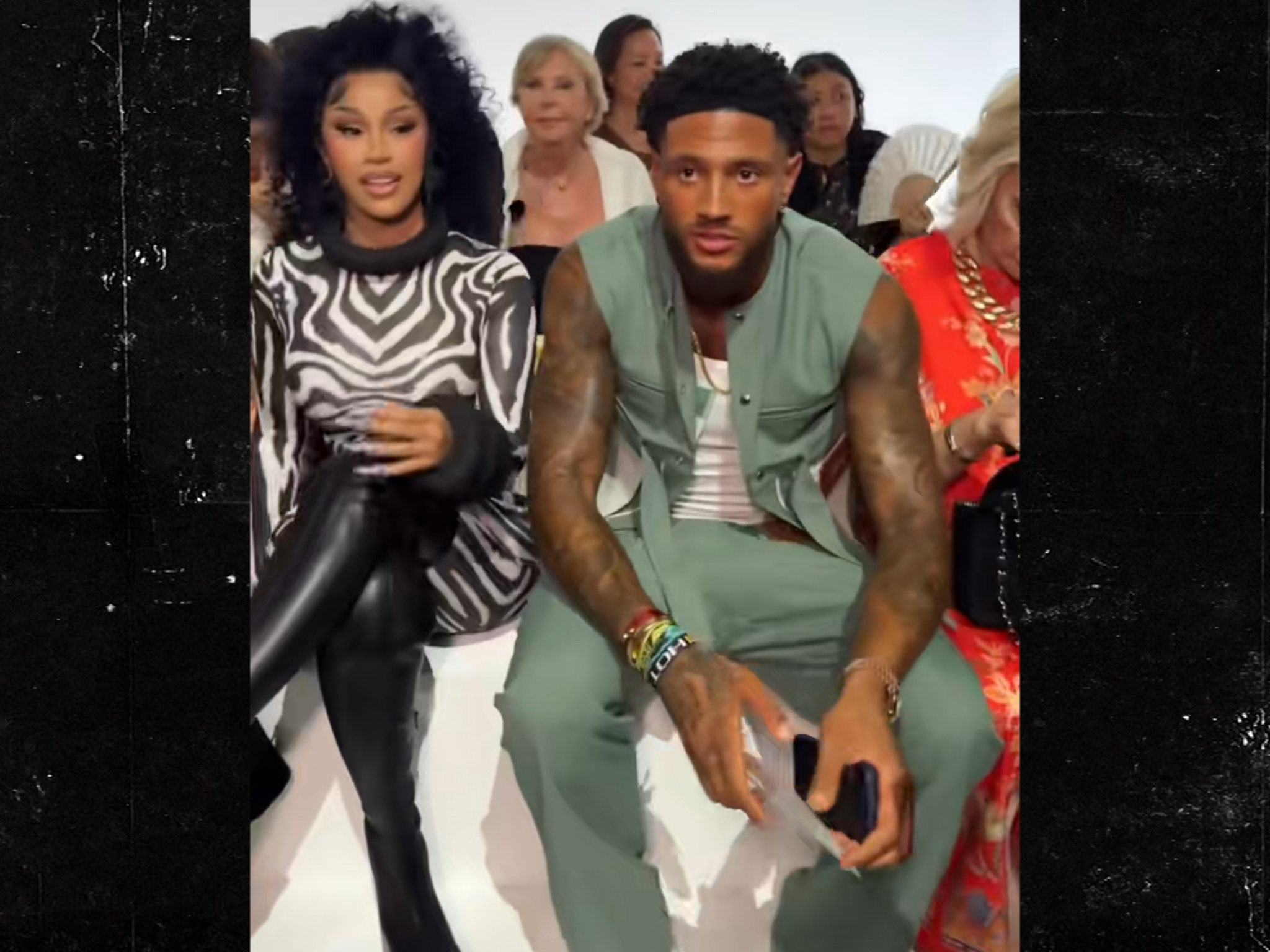 Cardi B seated beside Maduka Okoye at a Paris fashion event