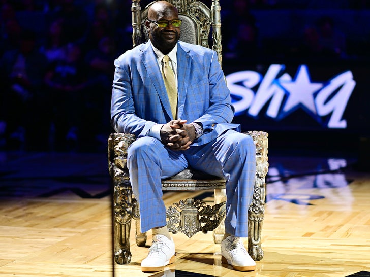 Shaquille O'Neal Sitting In A Chair On A Basketball Court