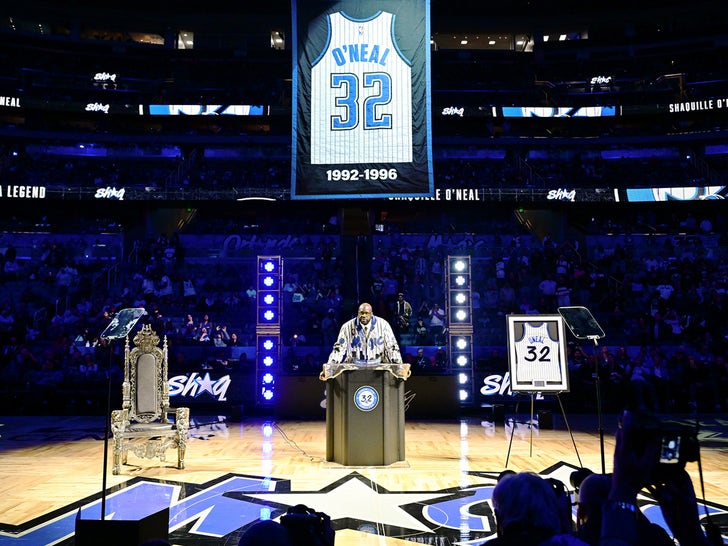 Shaquille O'Neal Speaking At A Podium On A Basketball Court