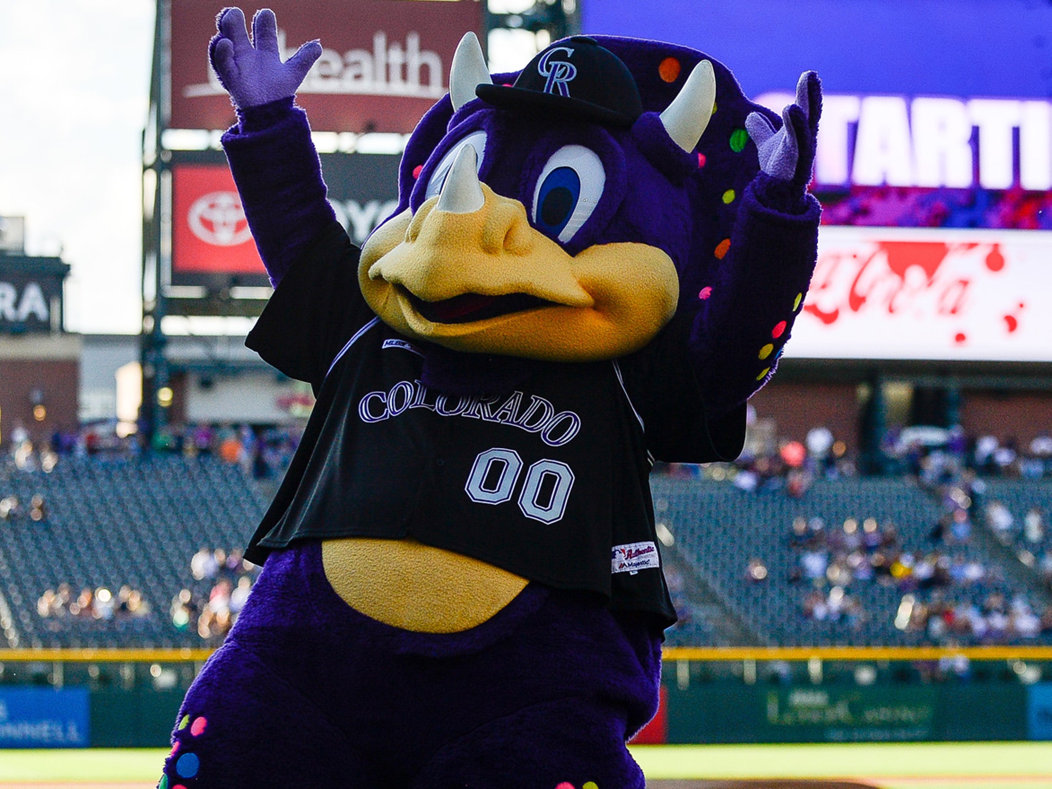 Colorado Rockies mascot dinger the dinosaur in the first inning of