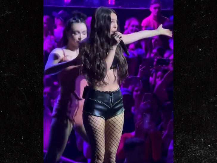 Singer Olivia Rodrigo suffers a wardrobe malfunction as her top pops off during concert