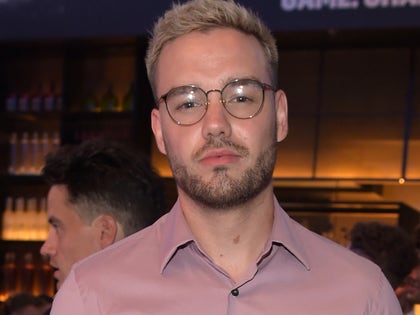 Liam Payne With Blonde Hair And Glasses In A Pink Shirt