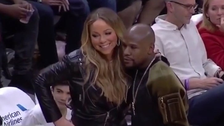 Floyd Mayweather Takes Picture With Fan At Clippers Game
