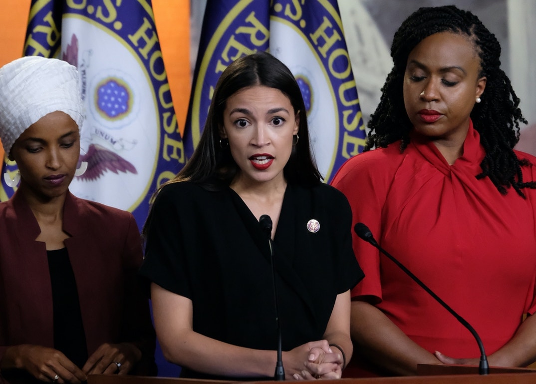 Rep. Alexandria Ocasio-Cortez (D-NY) speaks as Reps. Ilhan Omar (D-MN) and Ayanna Pressley (D-MA) listen during a news conference at the U.S. Capitol in Washington, DC. President Donald Trump stepped up his attacks on the four progressive Democratic congresswomen, saying that if they're not happy in the U.S. 