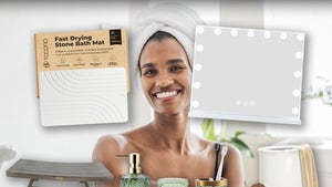 Woman Smiling With A Towel On Her Head In The Bathroom Surrounded By Bathroom Accessories From Amazon