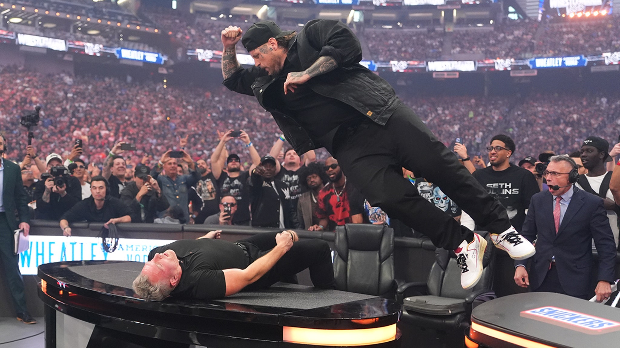 Jelly Roll Smashes Pat McAfee Through a Table at WrestleMania