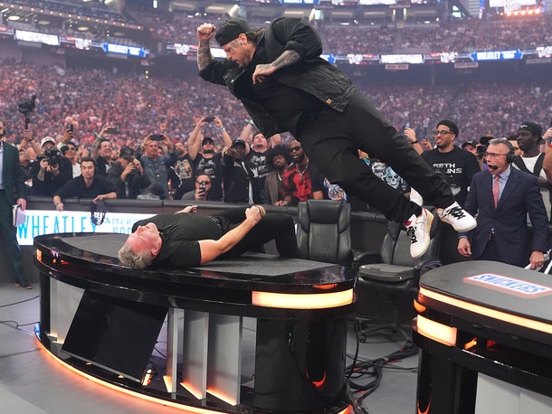 Jelly Roll Smashes Pat McAfee Through a Table at WrestleMania