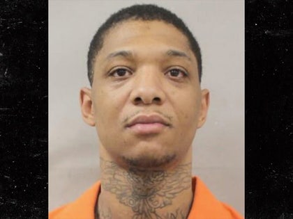 Derrick Groves is seen posing for a mug shot. He's wearing an orange prison jumpsuit.