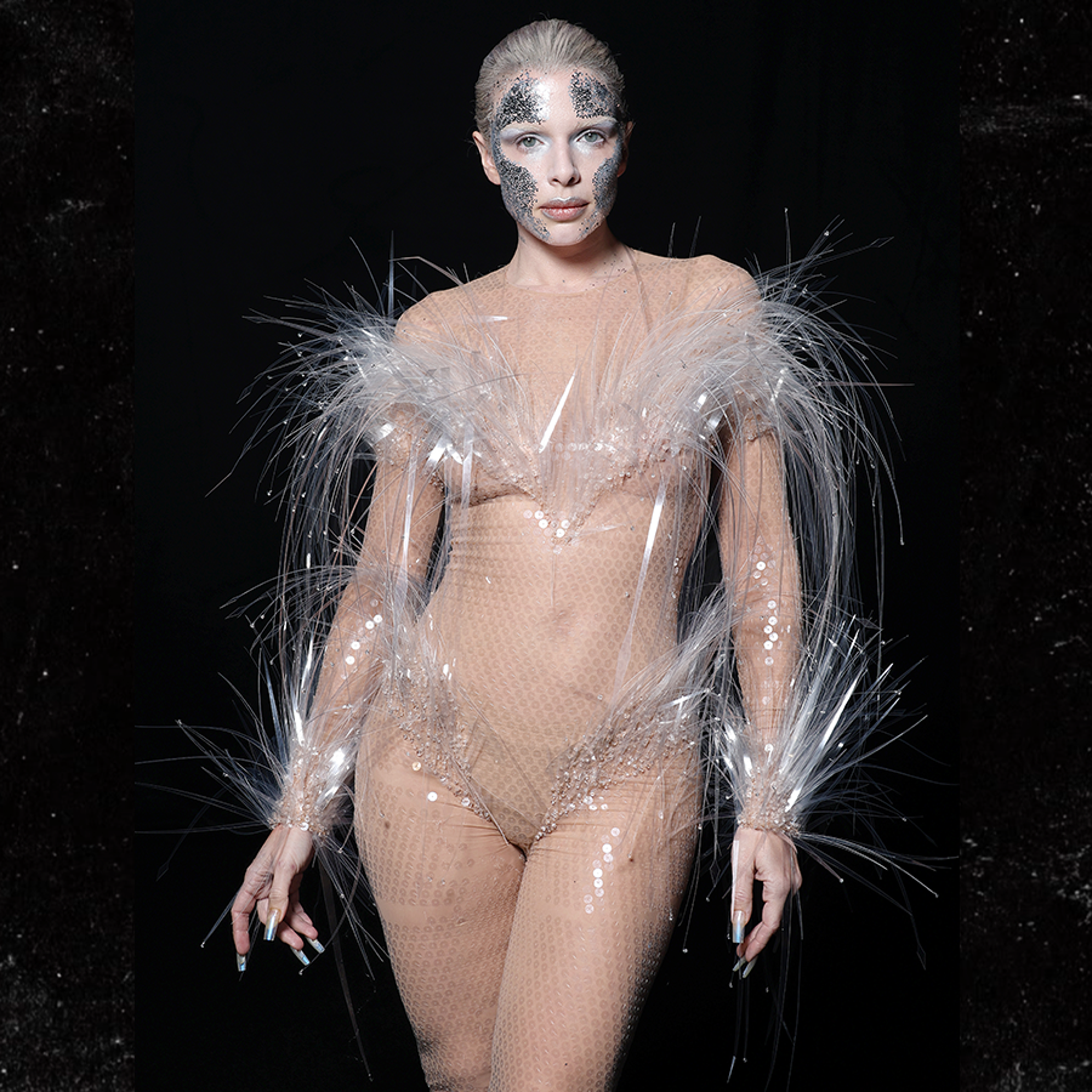 Julia Fox Wears Racy Nude-Colored Jumpsuit With Feathers & Face Paint