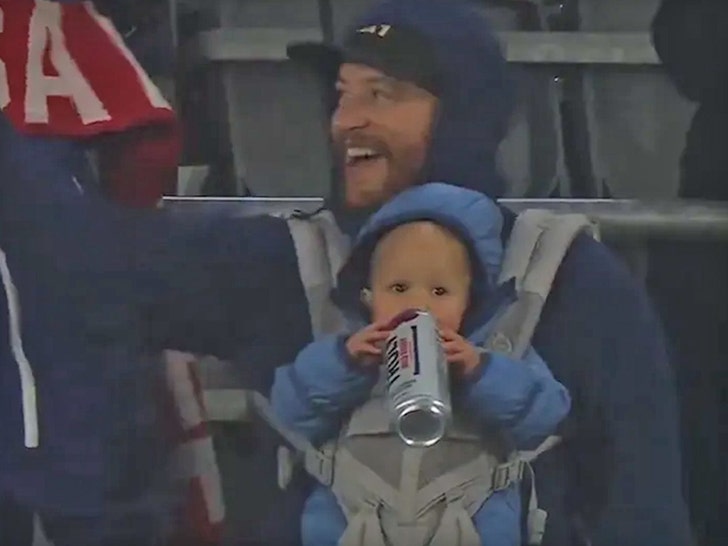 baby drinking truly at soccer game