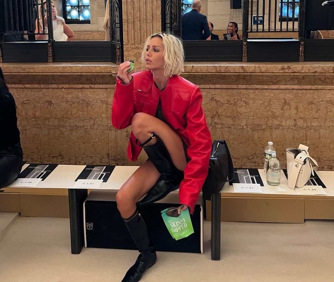Delilah Belle had the perfect accessory in the front row — SkinnyDipped Dark Chocolate Coconut Bites— during New York Fashion Week.