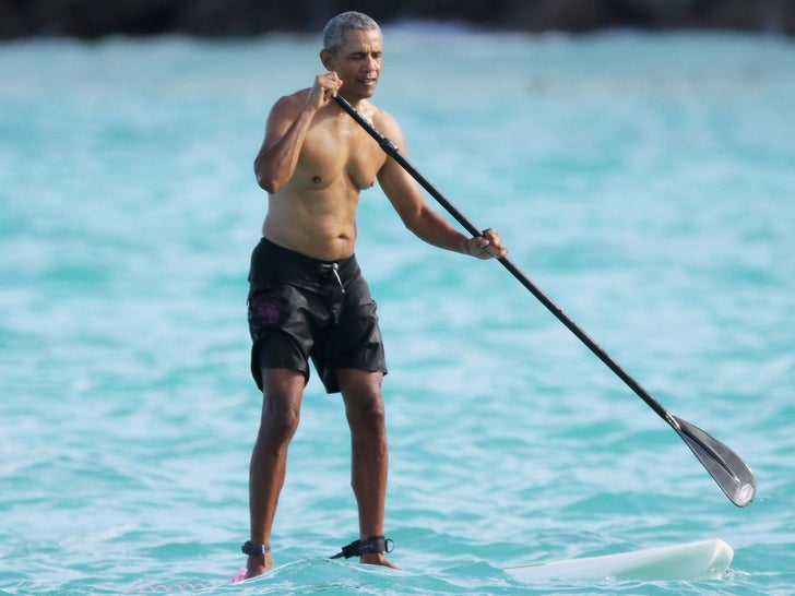 Barack Paddleboarding Shirtless In Hawaii