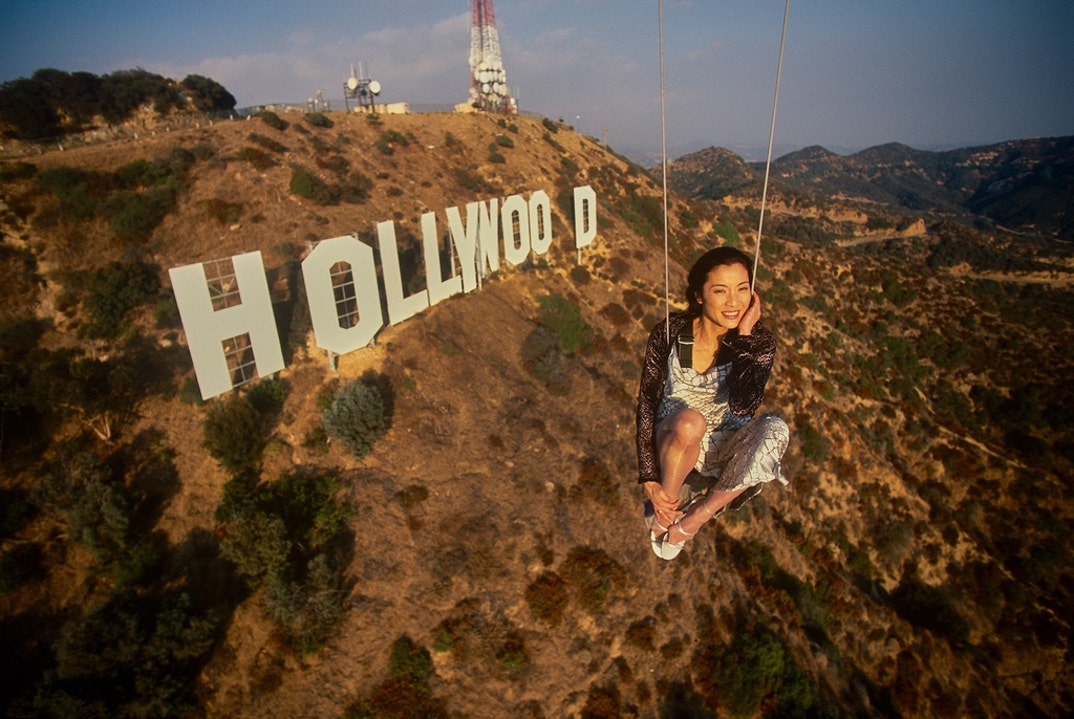 Actress Michelle Yeoh in mid-air over the famous Hollywood Sign in November 1998.