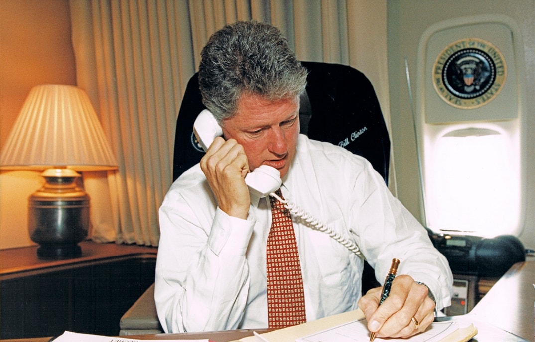 View of American politician US President Bill Clinton on the telephone during a flight on board Air Force One (en route from California to Washington, DC), October 5, 1993. He was speaking with President Boris Yeltsin.