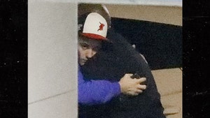 Justin Bieber Looks Sad as He Hugs His Bodyguard