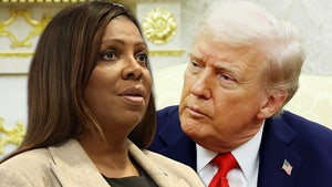 Letitia James is seen next to Donald Trump. She's wearing a beige coat and a black shirt, while he's wearing a blue coat, a white shirt, and a red tie.